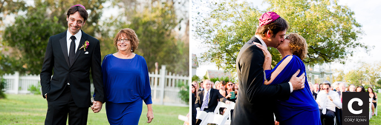 groom and mom walking down the aisle