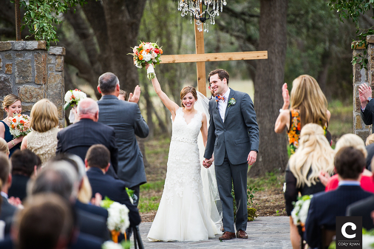 bride with her bouquet up