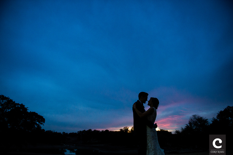 bride and groom silhouette with blue sky