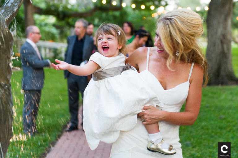 happy flower girl with bride at fountain