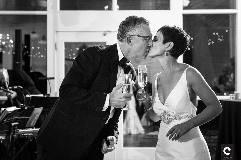 bride and groom toast and kiss