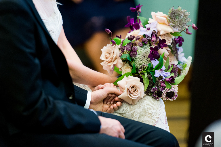 bride and groom holding hands during ceremony