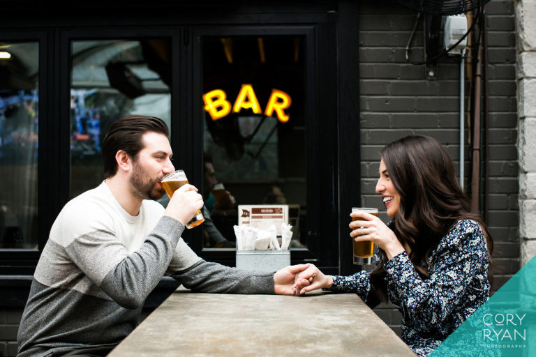 candid engagement photos at a bar