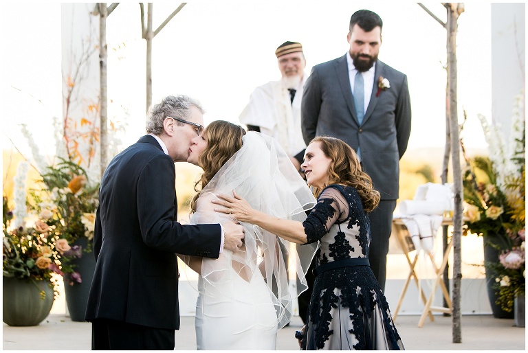 bride walked down the aisle by both parents